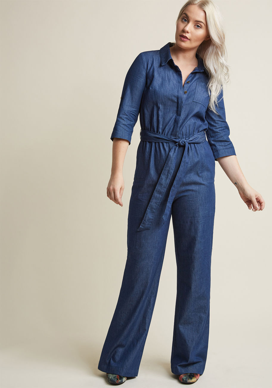 MCB1312 - While some may just see a sweet chambray jumpsuit, you see a landscape of style possibilities. Some strategic accessorizing can take the cropped sleeves, plentiful pockets, and matching sash of this ModCloth namesake label boiler suit from the office to a