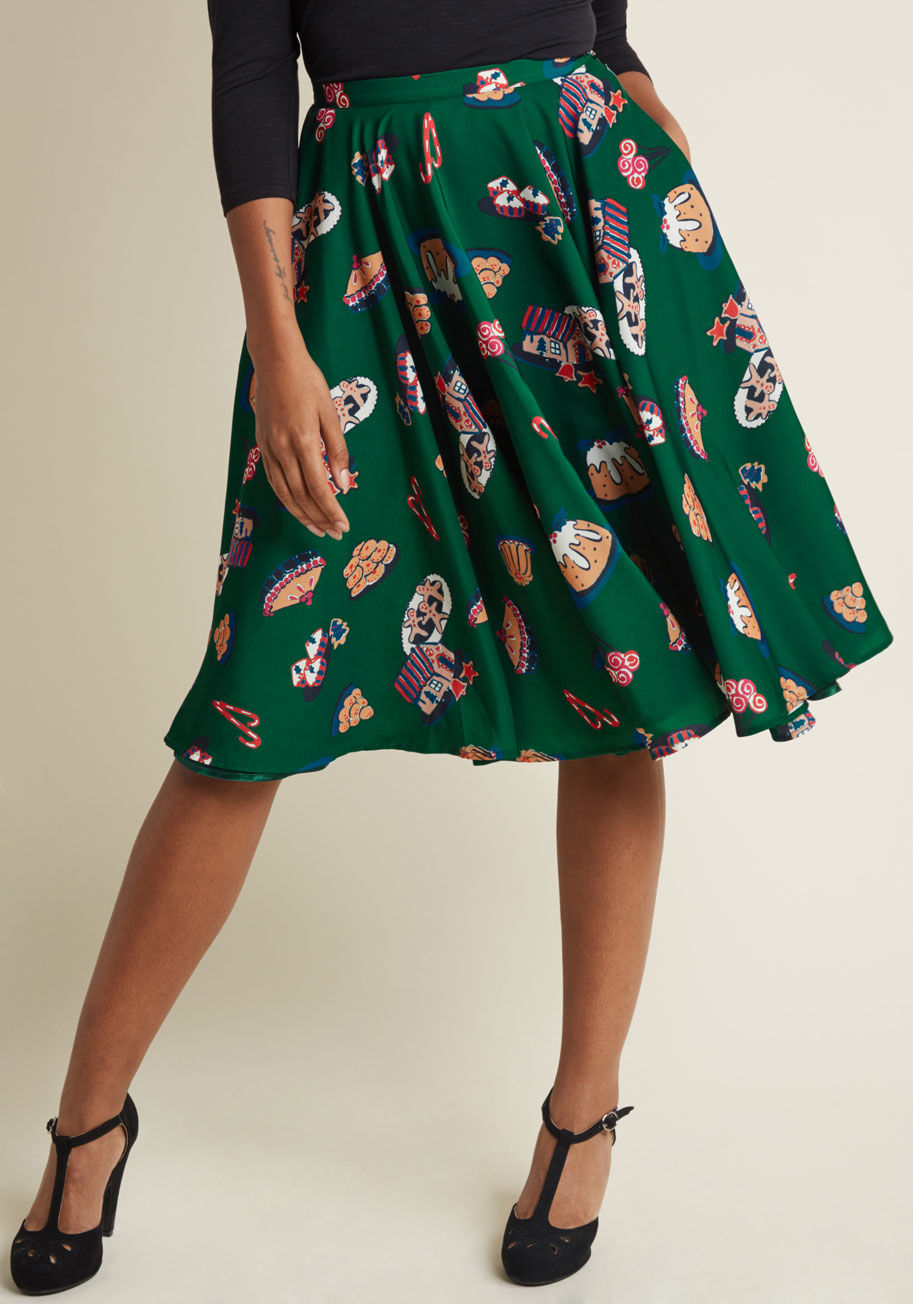 MCB1316 - Satisfy your style sweet tooth with this green midi skirt from our ModCloth namesake label! Sprinkling the retro silhouette of this high-waisted bottom with quirk is a vibrant print of gingerbread houses, fruitcakes, candy canes, and confections galore, b