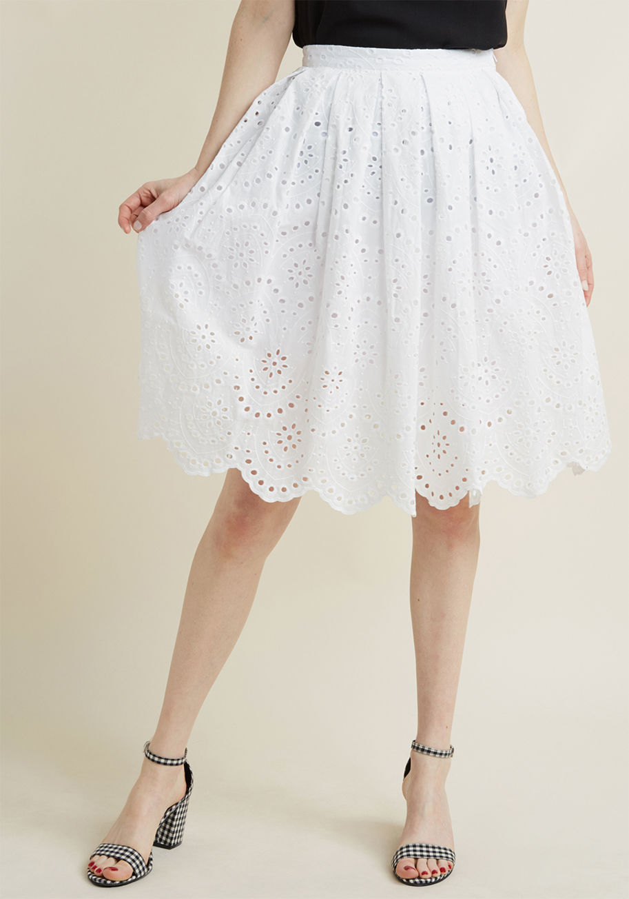 MCB1411 - There's no better invitation to flaunt this eyelet skirt than the promise of a brilliant forecast! A part of our ModCloth namesake label, this white A-line lends its subtle pleats, scalloped hemline, and classic vibe to all your forays filled with warm ra