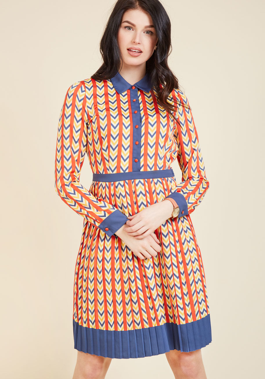 MCD1063 - As eclectic as the memos you transcribe, but as tidy as your organized desk, this retro shirt dress shows your colleagues you mean business! A pocketed part of our ModCloth namesake label, this pleated frock flaunts a primary-colored chevron pattern, a bu