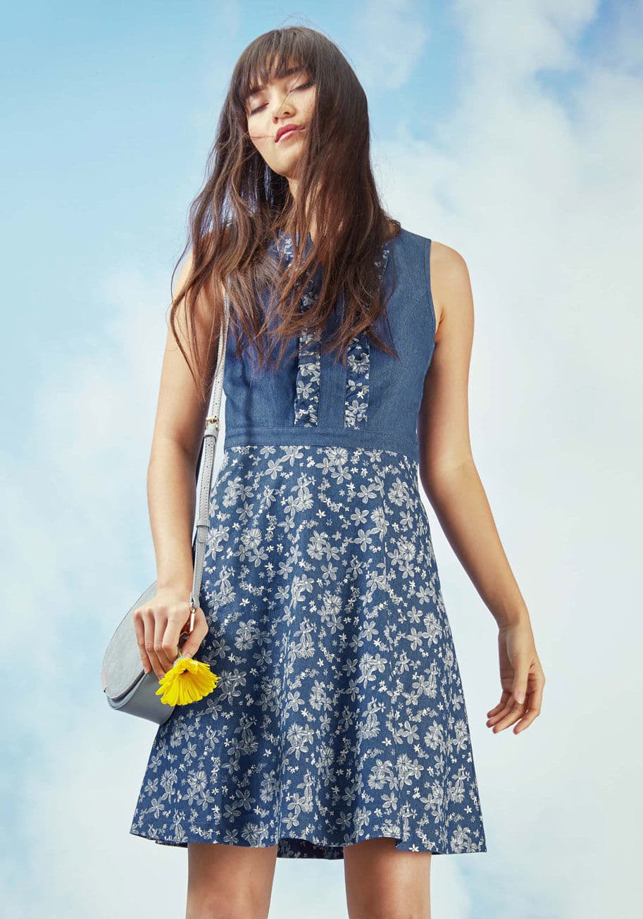 MCD1177 - Make a day of casual encounters an opportunity to impress with this chambray dress! From your favorite barista to colleagues aplenty, everyone will swoon for the ruffle-framed V-neck and pocketed, floral skirt of this charming A-line from our ModCloth nam