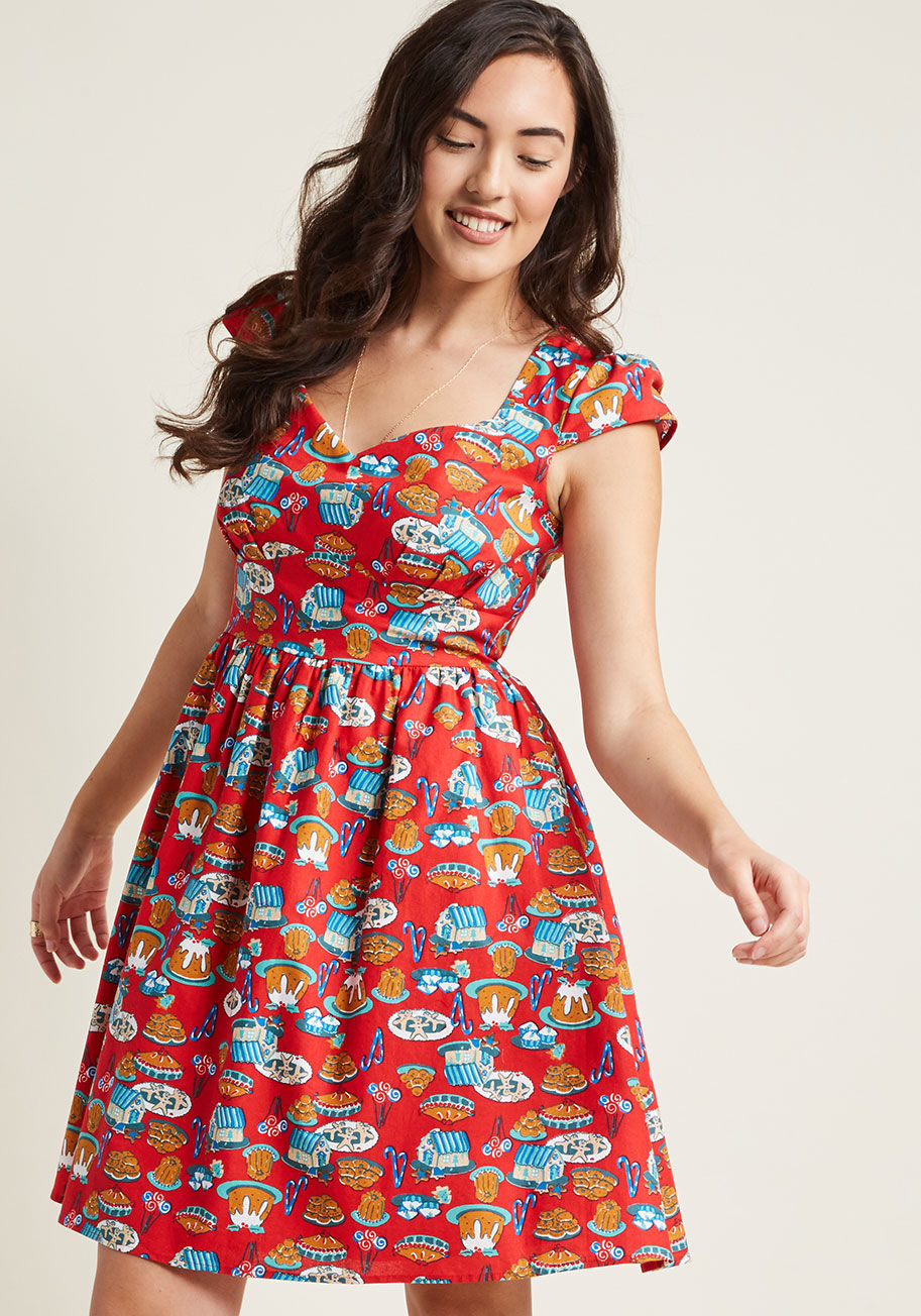 MCD1293A - This holiday dress is marvelously merry and bright! Flaunting a sweet spread of festive desserts atop its vibrant red hue, cap sleeves, and a sweetheart neckline, this cotton piece from our ModCloth namesake label heralds the holiday season with a hint of