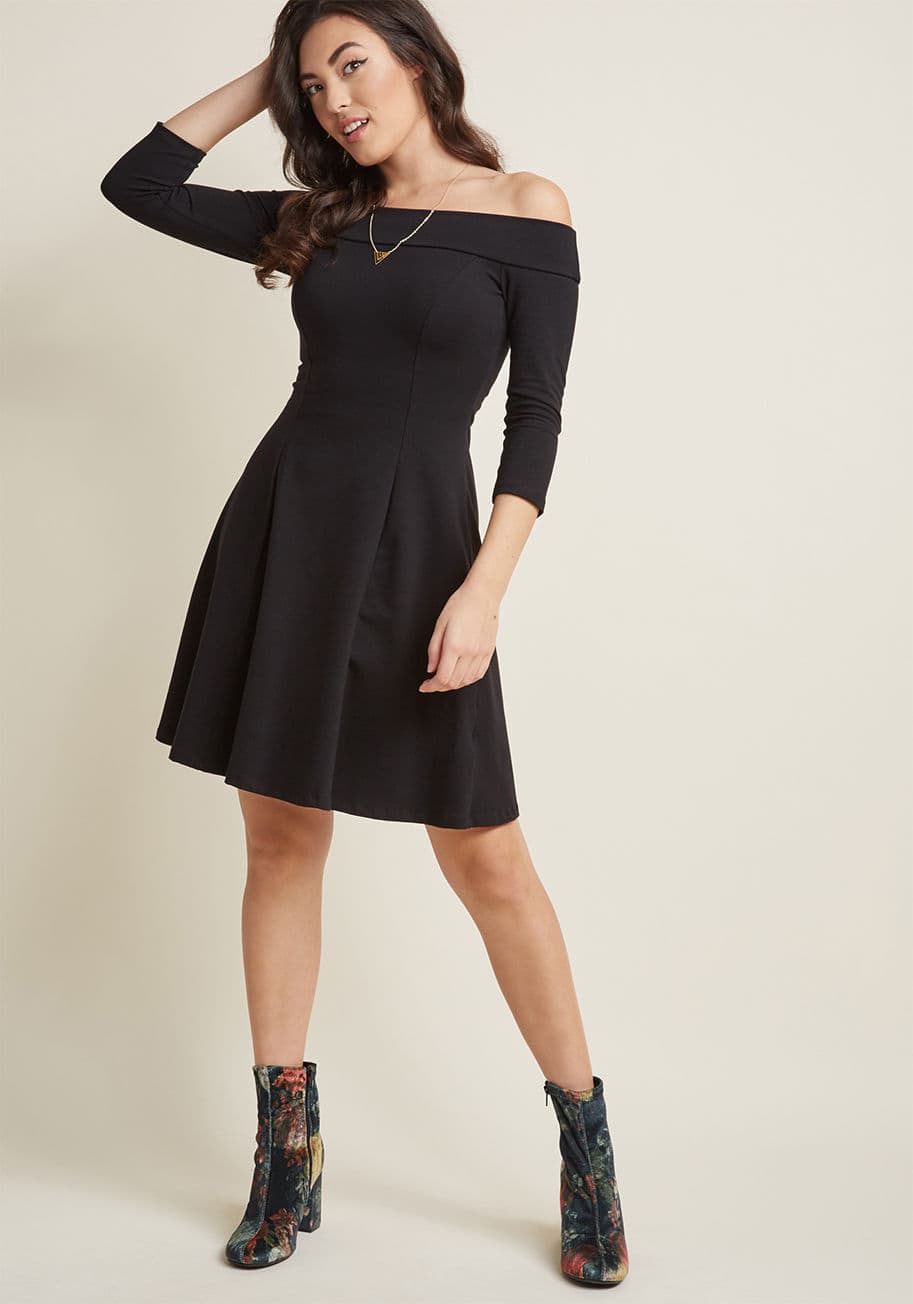 MCD1448 - Who knew an A-line dress so sassy and stylish could simultaneously be so comfy to wear? Part of our namesake label, this black, jersey knit skater dress is characterized by an off-the-shoulder neckline, 3/4-length sleeves, and oh-so-much personality!