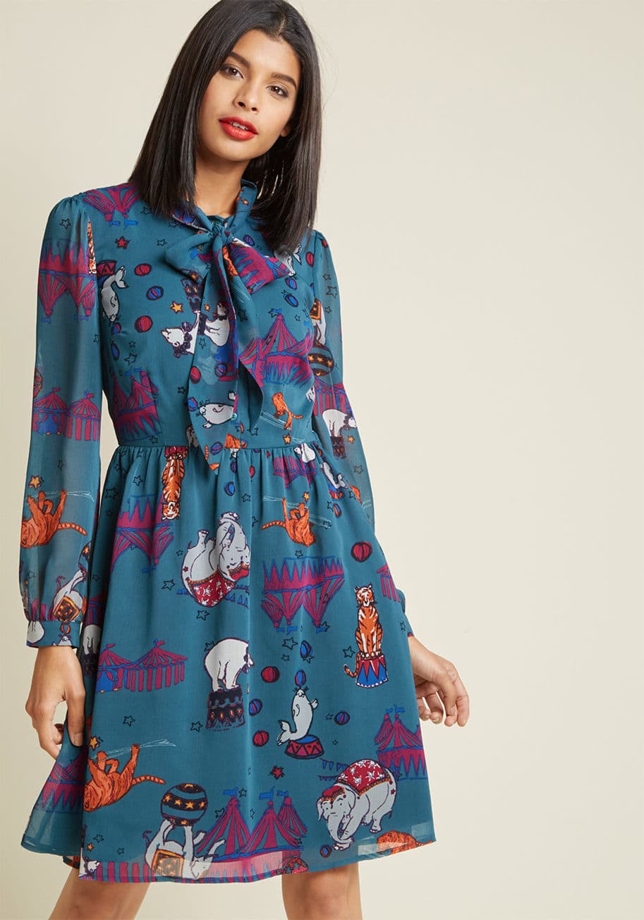 MCD1459 - The perfect dress should be designed to delight, which this blue shirt dress certainly is - and offers much more! Part of our ModCloth namesake label, this chiffon A-line features a tie-neck, a buttoned placket, long sleeves, and a beautifully illustrated