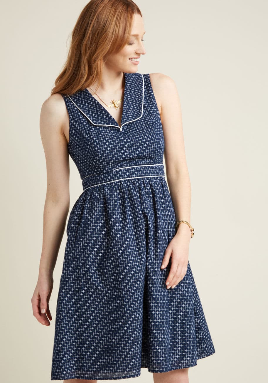 MCD1485 - With sleek white piping and petite plus signs woven throughout, this navy blue dress is a symbol of affirmative style! A totally retro number from our ModCloth namesake label, this woven A-line is punctuated with an old school collar, a defined waist, hid