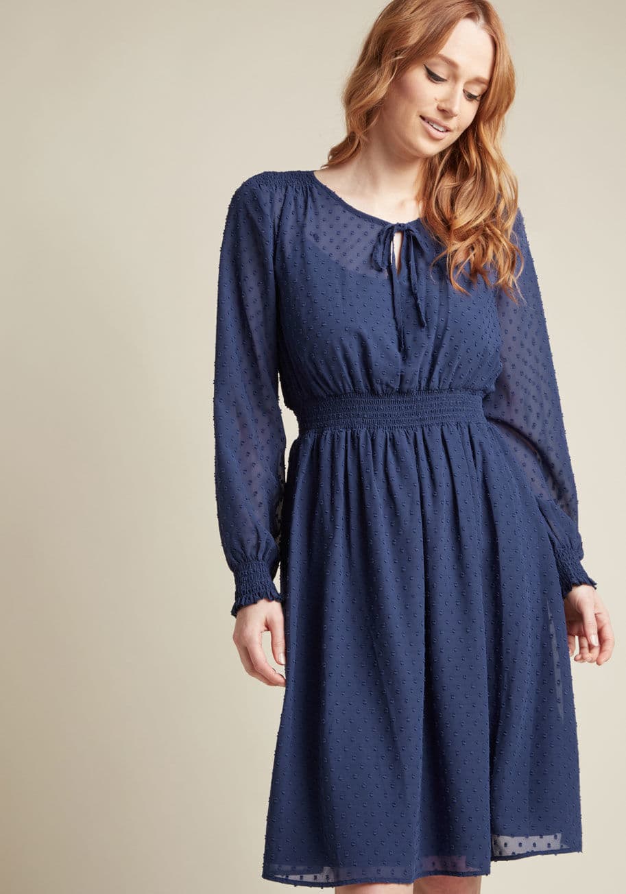 MCD1489 - Come for the color, stay for the texture! This long sleeve dress' charming clip dots are just as delightful as its bold blue hue. Fashionable for a variety of functions, this vintage-inspired frock features smocking at the shoulders, sleeve cuffs, and wai