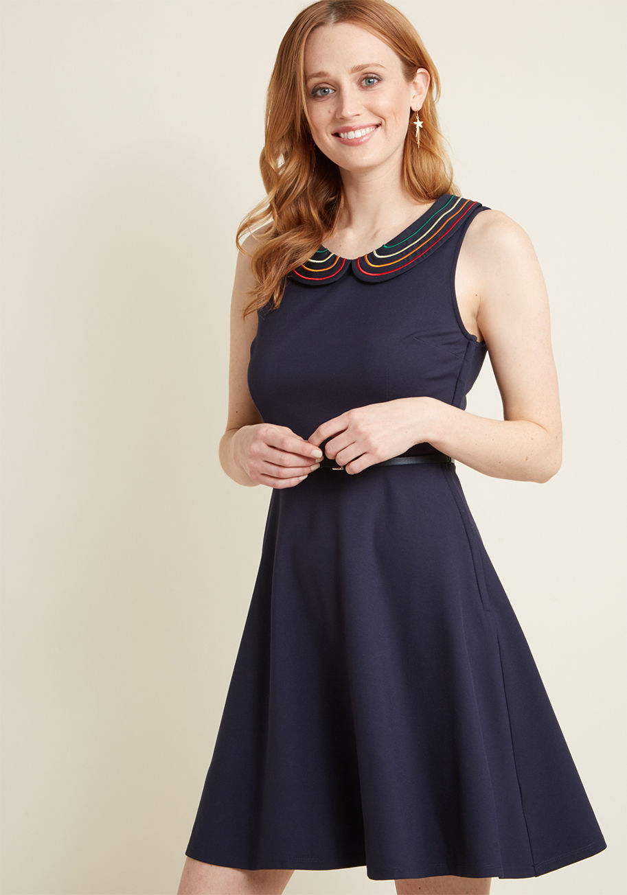 MCD1567 - When your day is filled with on-the-go excitement, rely on this ModCloth-exclusive dress to keep up with your busy schedule! Boasting a navy blue hue, a rainbow-embroidered Peter Pan collar, and a thin belt, this knit A-line will carry you from meetings a