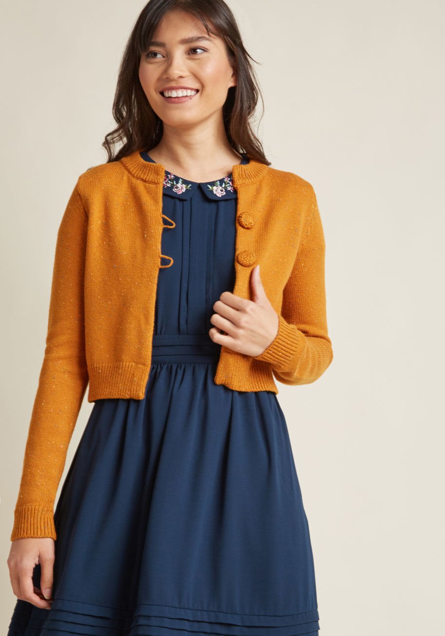 Mcs1152 - Your retro cardigan collection will finally feel complete with the addition of this cozy sweater from our ModCloth namesake label! Touting a mottled knit motif, a pair of crochet-covered buttons, and the ultimate cropped cut of '50s fashion, this pumpkin-