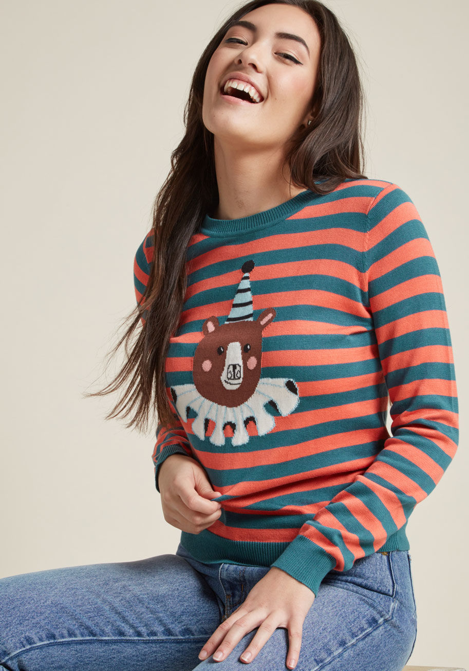 MCS1171 - Take the carnival with you wherever you go by sporting this striped sweater - part of our ModCloth namesake label! Taking center stage with its blue and coral hues, quirky intarsia bear, and fun-filled charms, this cozy knit pullover brings a warm smile t