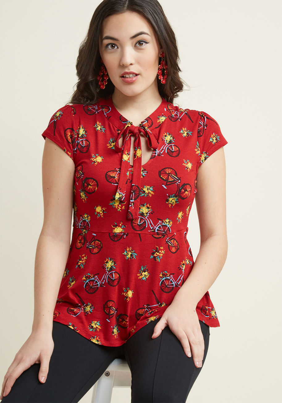 MCT1140D - Are you up for a look that's enlivened with flirty detailing and brilliant bikes? Then turn your attention to this red top from our ModCloth namesake label! Between the lightly puffed shoulders of this knit number is a tied neckline, situated elegantly at