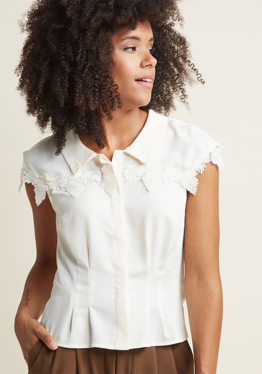 Mct1452 - Ready to rock your most retro look to date? This tailored blouse is it! Part of our ModCloth namesake label, this ivory button up will make you smile with its dimensional leaf appliques along the chest and cap sleeves, and slightly cropped silhouette. Liv