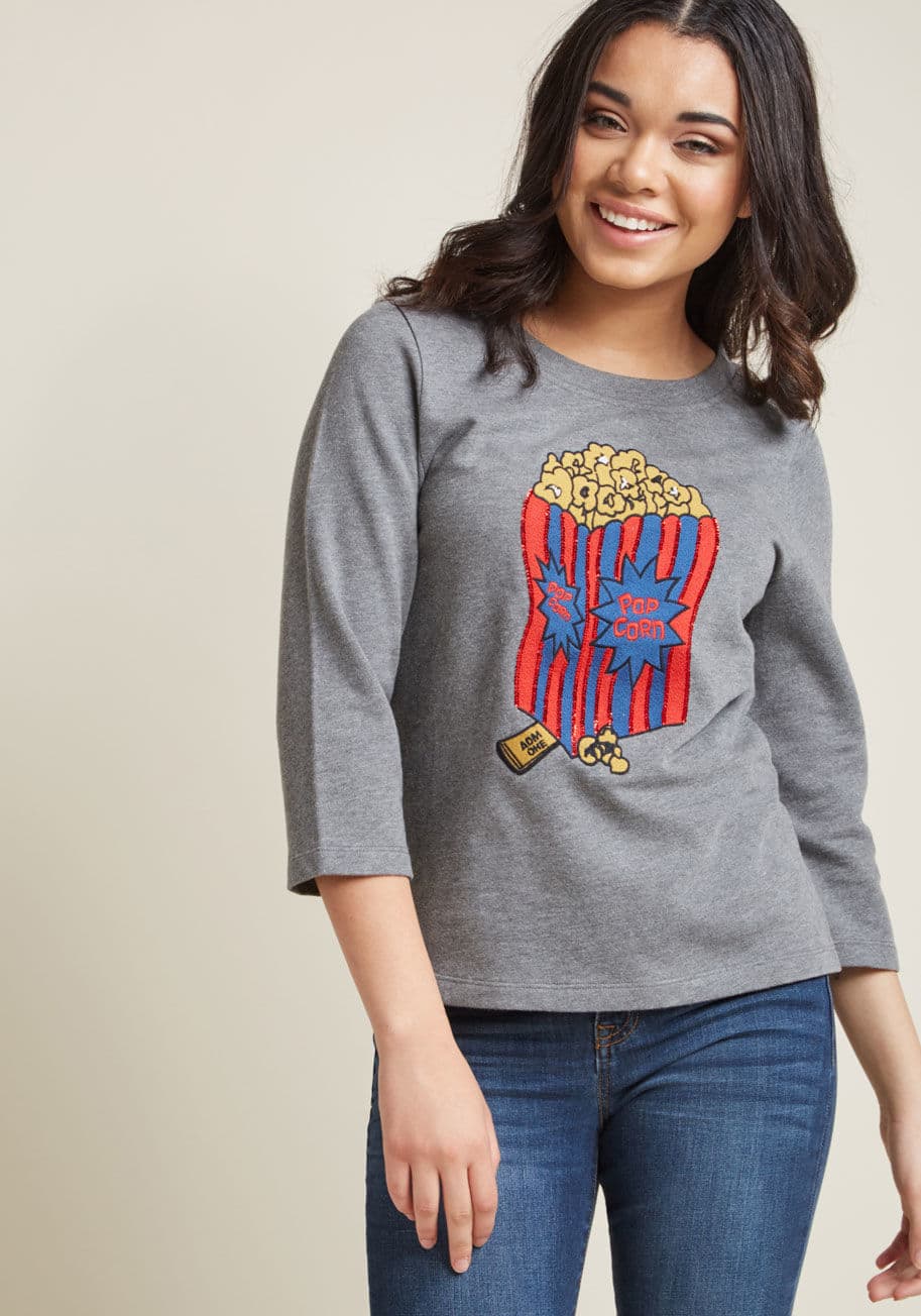 MCT1516 - For the stylista who also considers herself a 'snack'-ista, this heather grey sweatshirt will be a welcome wear! Part of our ModCloth namesake label, this cozy pullover features cropped sleeves, vented sides, and a boldly embroidered popcorn graphic accen