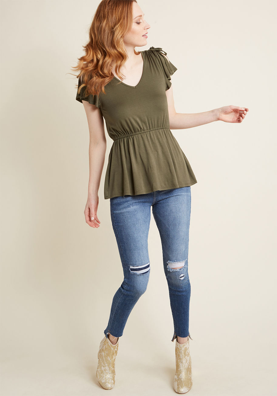 MCT1601 - Experience the thrill of a flaunting a fresh aesthetic with this olive green top - even after its debut wear has long passed! With sleek ties ruching each shoulder, vents adding moment to its cap sleeves, and a peplum detail finishing the look, this ModCl