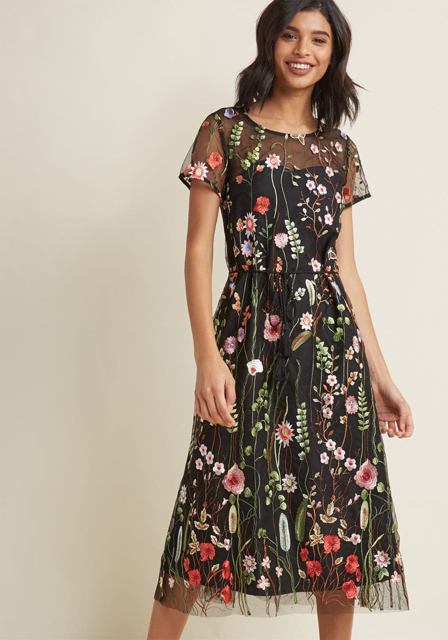 MDD1211 - In the depths of your sartorial imagination, there lies the optimal frock - could it be this black midi dress from our ModCloth namesake label? With its gorgeous embroidered flowers atop a delicate mesh overlay and tassel-accented sash, this stunning numb