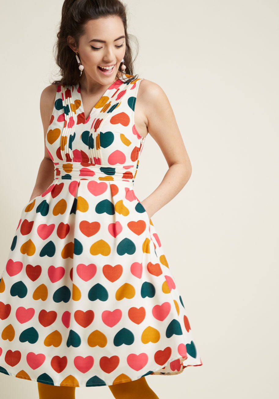 MDD1243 - There's no questioning just how darling you look, especially when this ivory fit and flare is involved! From our ModCloth namesake label, this playful dress bolsters your charm with its pintucked neckline and waist, hidden pockets, and colorful pattern of