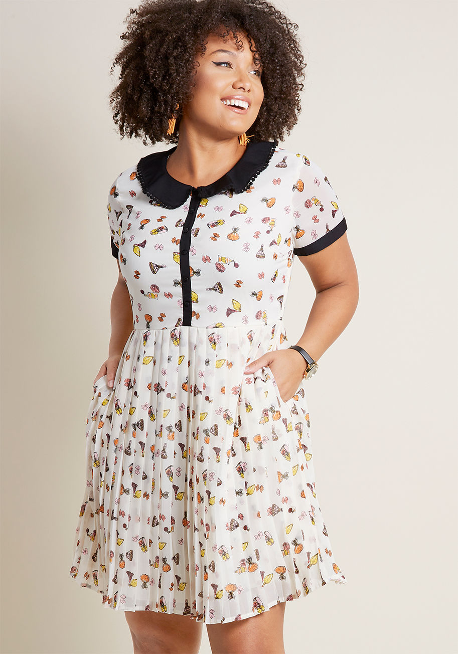 MDD1261 - There's no denying the personality you exude from flaunting this ivory shirt dress from our ModCloth namesake label! A black collar fancied up with dotted trim tops this chiffon number, playfully interacting with its sheer short sleeves, warm-toned patter