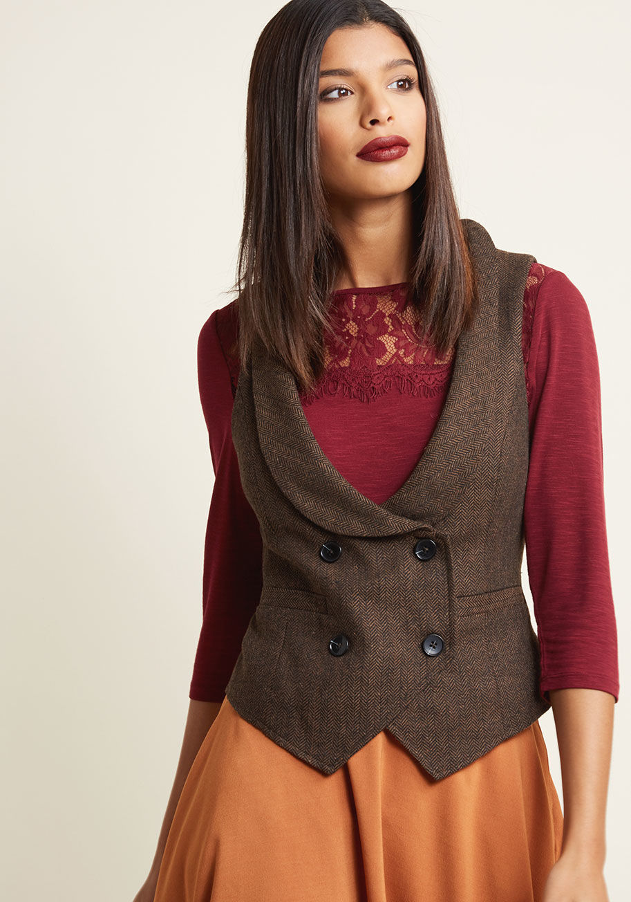 MDO1018 - Mondays can be tough to dress for, but this brown vest from our ModCloth namesake label removes any trace of mystery from the equation! With a lapel-flanked scoop neckline, a double-breasted button closure, and a pointed hemline, this pocketed herringbone