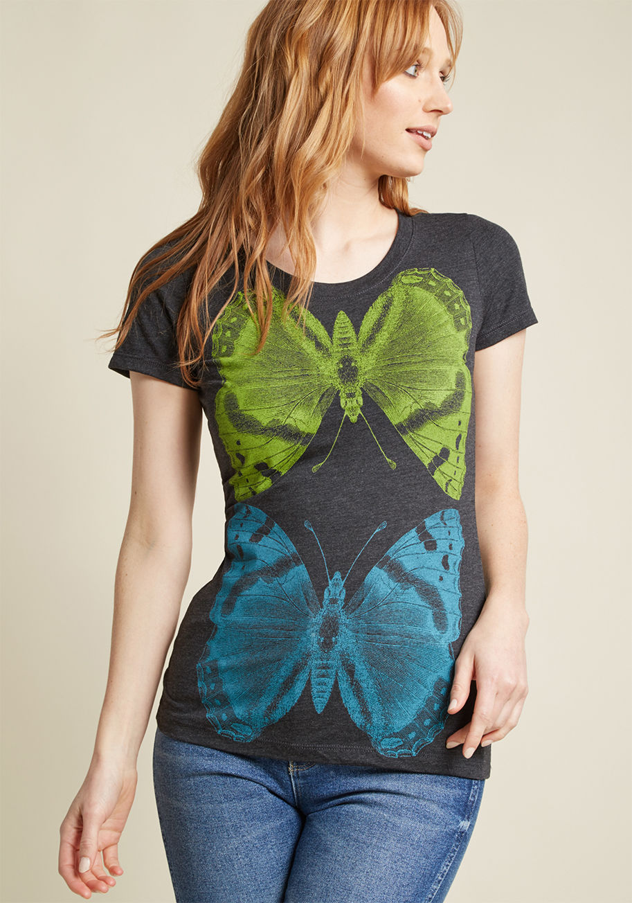 MOT-PEN-HCH - Indoor voices? Forget 'em! Your pals will exclaim with glee over the way you flaunt this grey graphic tee! Supportive shouts will abound for the green-and-blue moth motif of this Supermaggie T-shirt, hand printed right