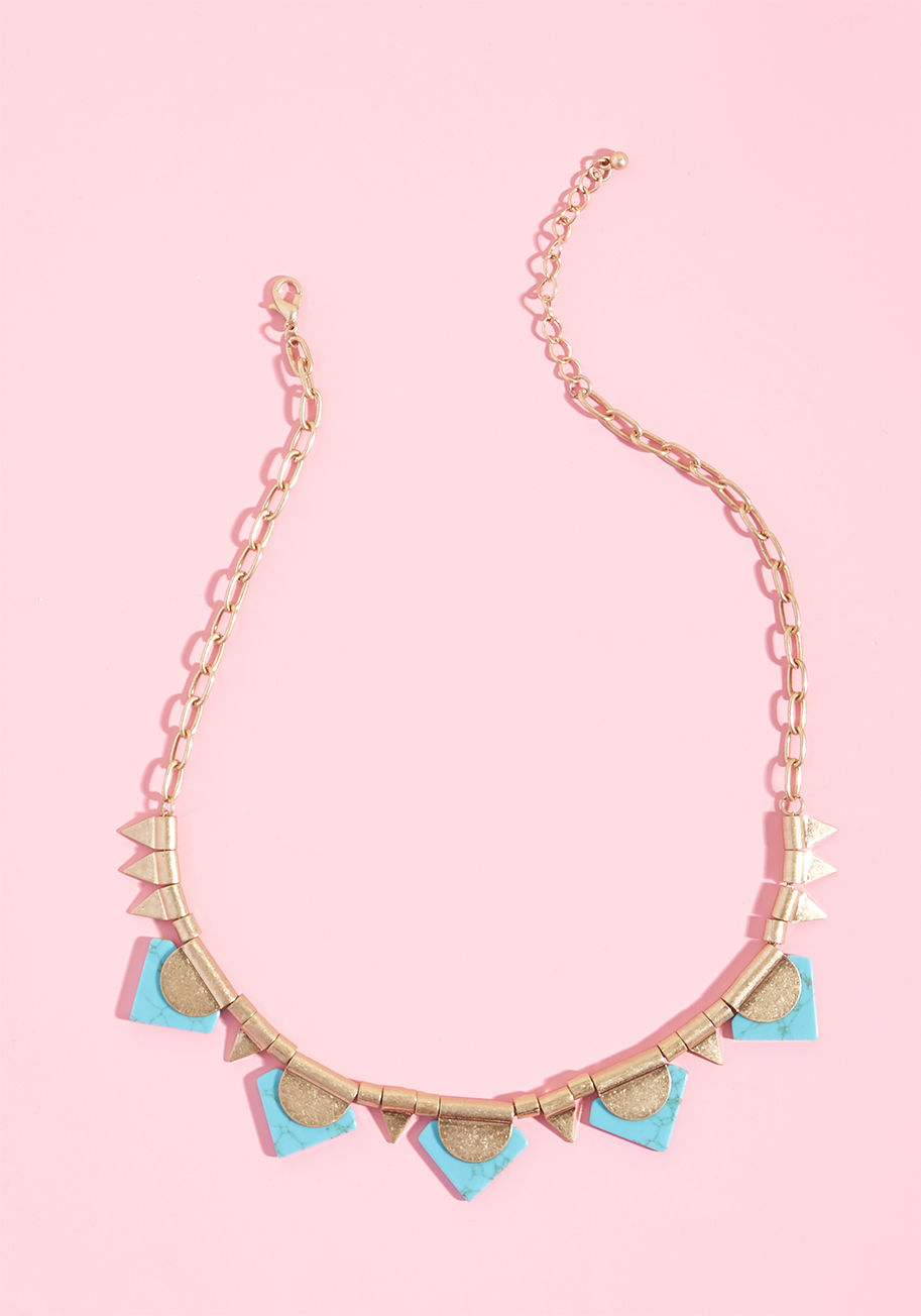 MTM05-1110 - Add a sprinkle of Southwestern flair to your favorite ensembles with this geometric necklace! Touting shining gold accents and pointed turquoise faux stones, this charming, ModCloth-exclusive accent gives your best looks their 'just deserts'.