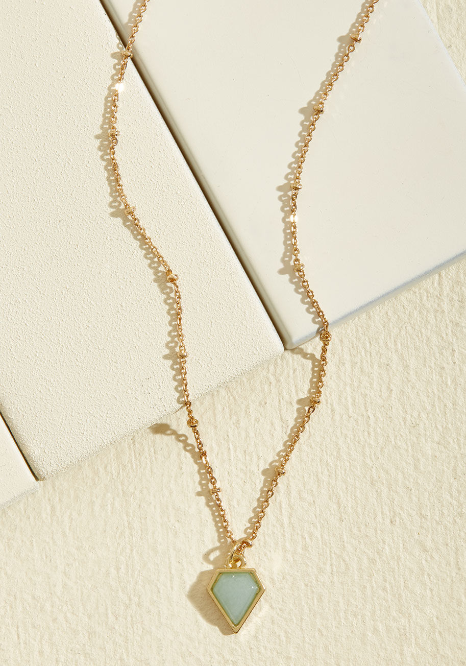 MTM06-1112 - Though the addition of this delicate pendant necklace to your outfit is a simple one, it definitely makes an elegant impression! A gold, beaded chain supports the geometric mint charm of this minimalist, ModCloth-exclusive piece for a finishing touch you'