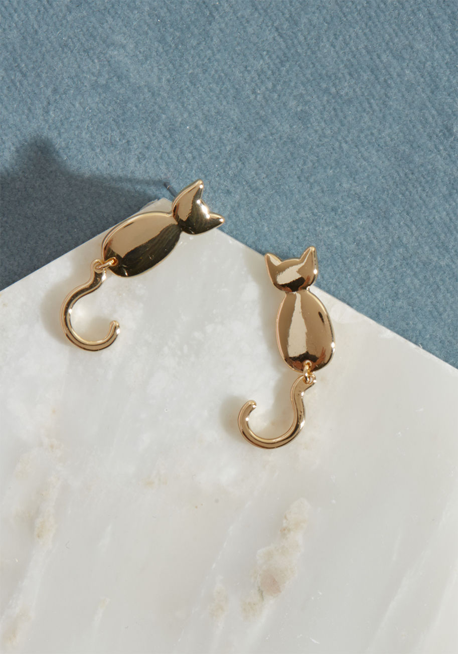 MTM07-3089 - As the curved tails of these gold cat earrings wag along with your every step, you shake along with their joyful aesthetic. A ModCloth exclusive, this shiny pair is that'll have you always 'feline' like showing 'em off!