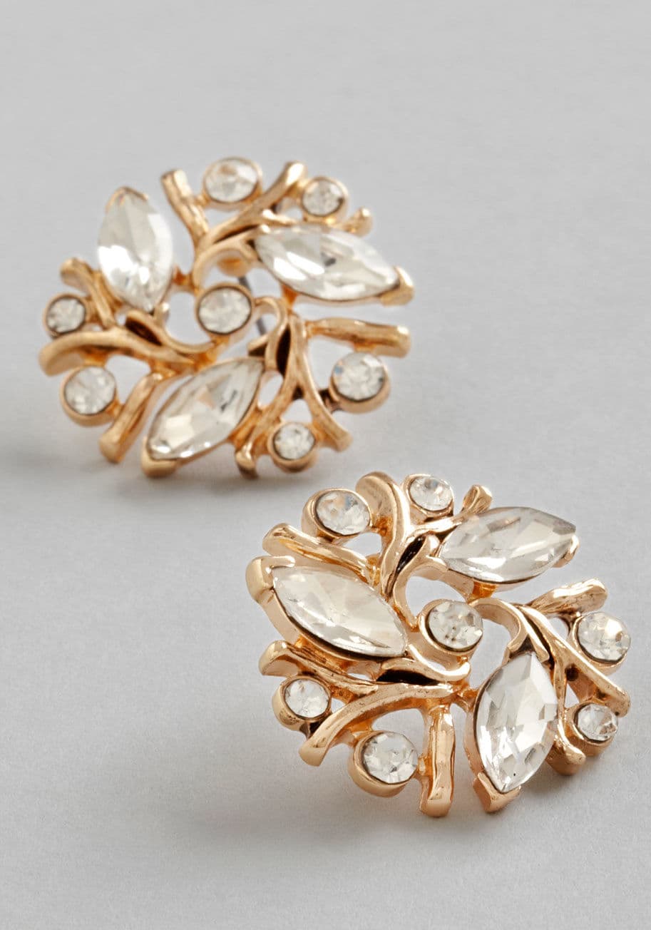 MTM14378 - Whether it&rsquo;s a cool breeze blowing your hair past these post earrings or a quick gust that offers an element of surprise, the most beautiful day you&rsquo;ve ever known is embellished by this pair. Upon a gold, sprig-like settings, rhinestones swirl