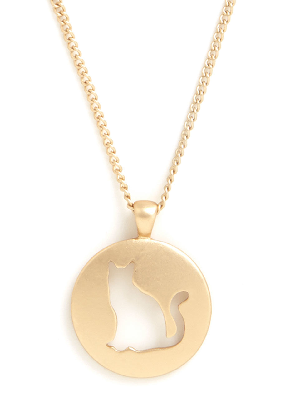 MTM15139 - You love your furry feline friends - so much so that you often sport this cute cat necklace! The silhouette of a sitting feline is cut out from the circular, smooth gold pendant of this ModCloth-exclusive necklace, letting the pattern of your blouse under