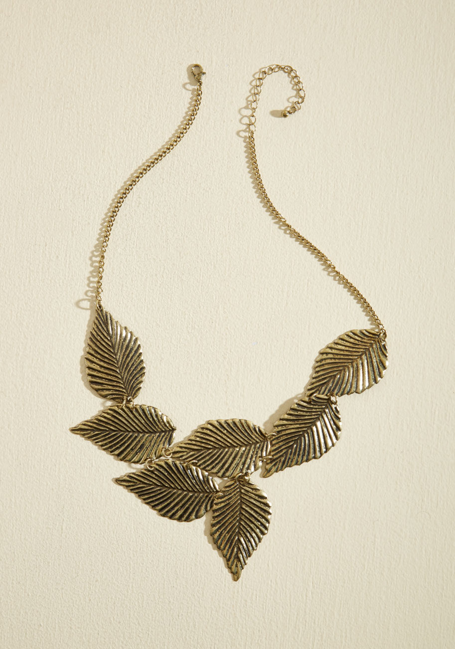 MYB5426 - When packing for a weekend getaway, choose your accessories wisely - you can get the most use out of very versatile items like this linked gold leaf necklace, as featured