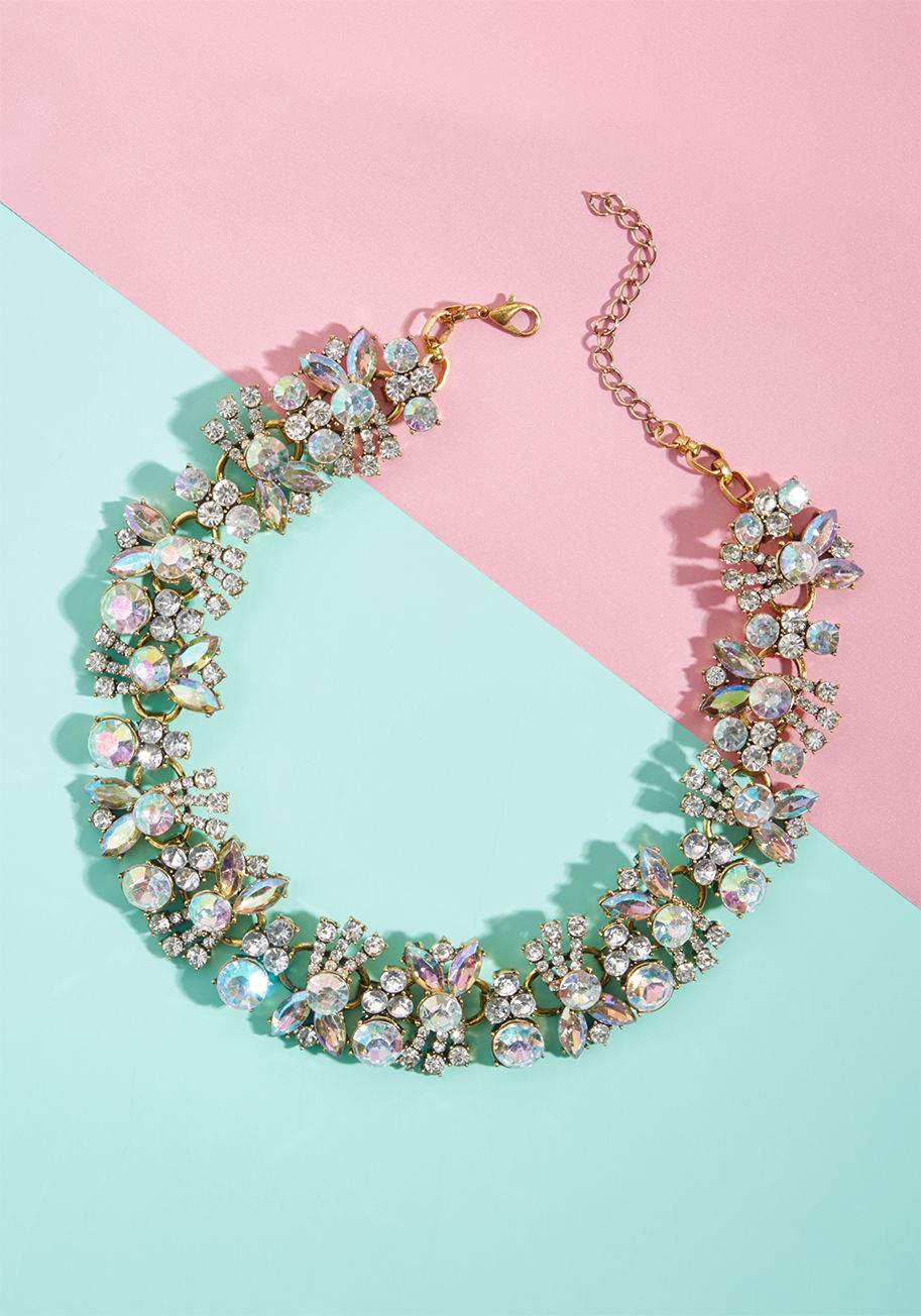 NA66650 - Get ready, gals, 'cause this statement necklace is soon to glam up the entire room! Glistening rhinestones take on iridescent touches and flower bud-inspired shapes, all set