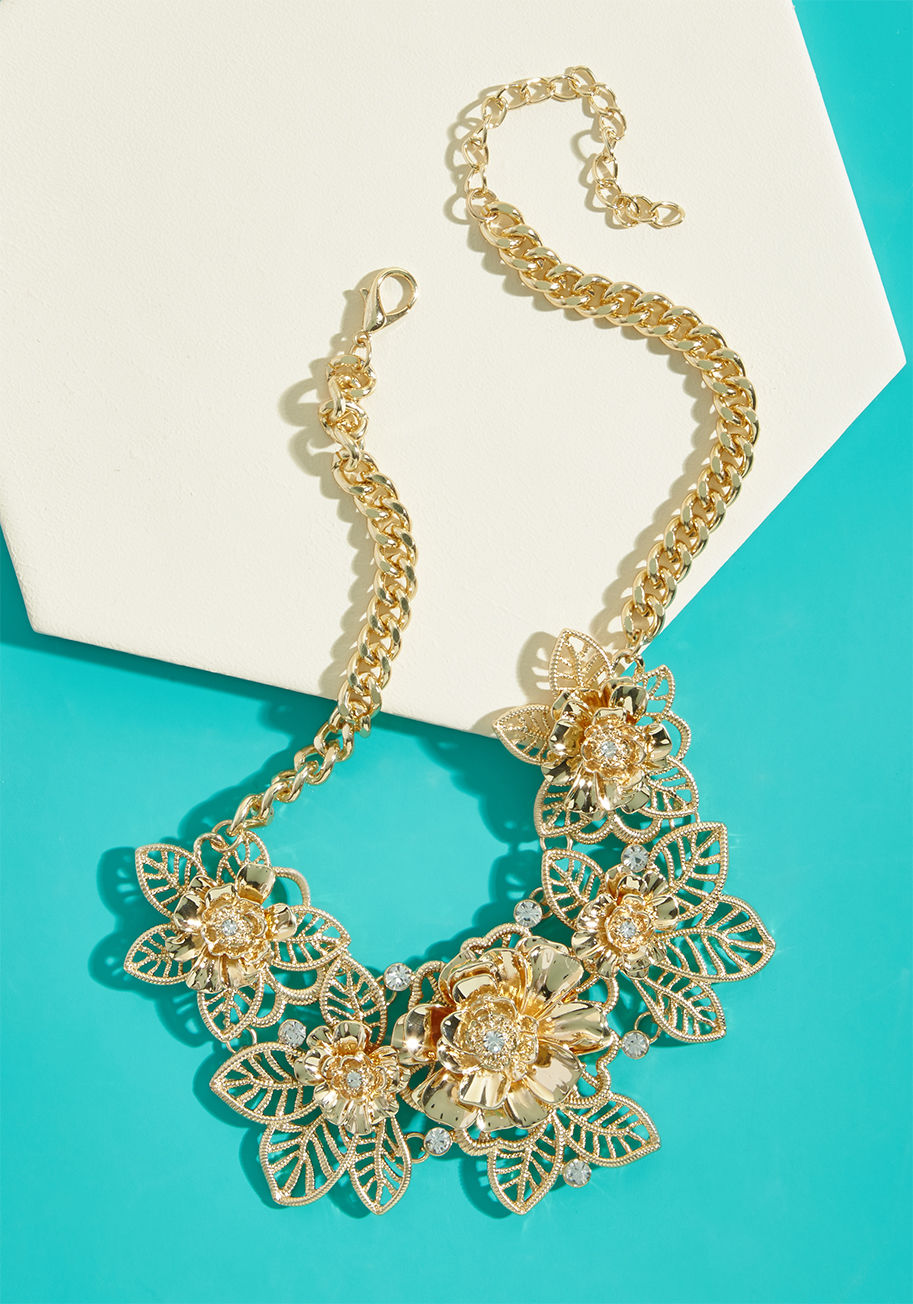 NA66966 - Infuse any look you choose with infallible femininity, courtesy of this gold necklace's stunning motif! Quite the fresh-picked accessory, this opulent add-on boasts shining rhinestones, textured petals, and gleaming leaves atop a braided chain - all detai