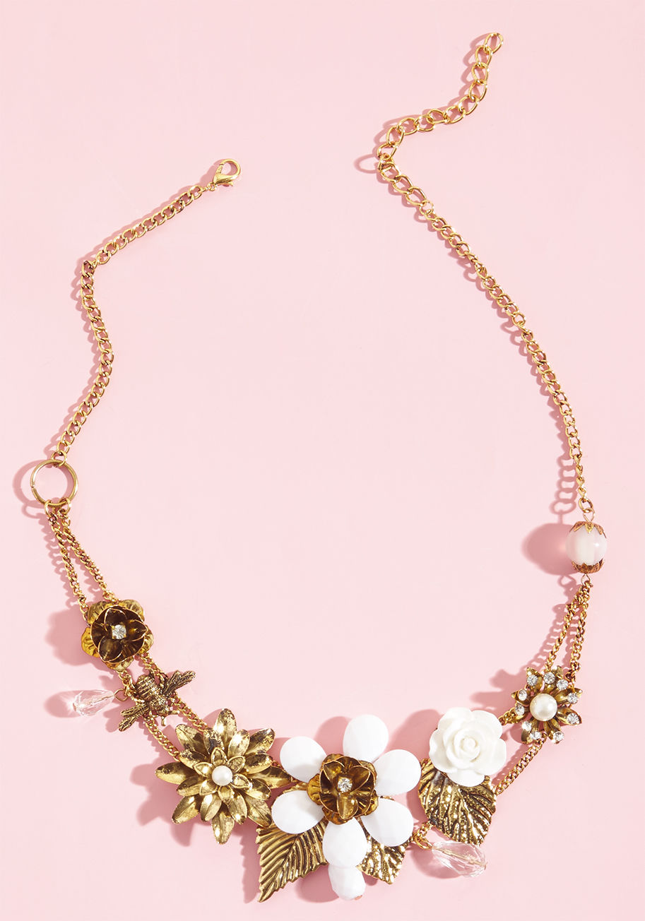 NA66969 - Harness the energy of your inner elegance by clasping this gold statement around your necklace, and seeing where its fine design takes you! Rhinestones, faceted beads, faux pearls, white-detailed flowers, and a single bee accent contribute to the inspirin