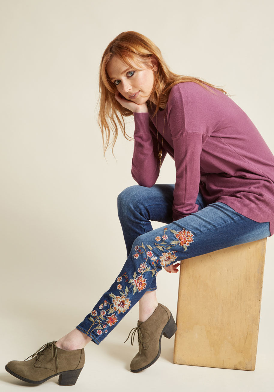 P4018A - If you're a free-spirited gal, then these skinny jeans from Driftwood are a must-have! Embroidered at the hip, pocket, and leg with a burgundy, burnt orange, beige, and sage floral design, this washed denim pair will exhibit your independent ideals with t