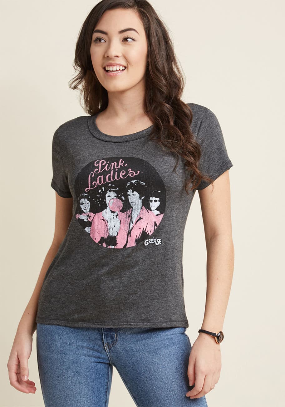 PP-GRS103 - Celebrate the OG girl gang with this grey graphic tee! Cleverly crackled atop its Pink Ladies screen print for a vintage-inspired look and feel - the perfect accompaniment to its slub fit - this Grease piece is one toe-tappin' throwback.