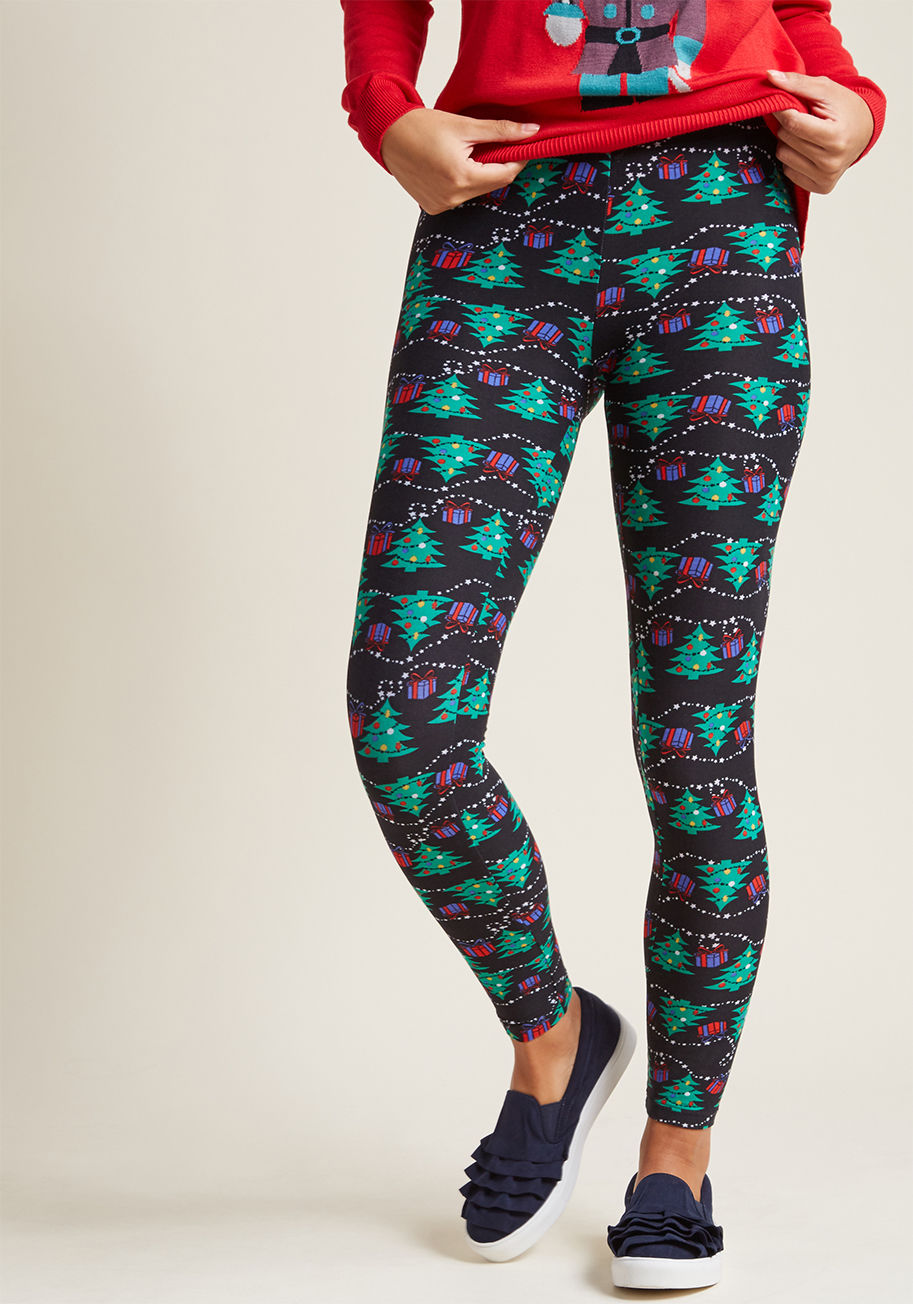 PR202654 - Guarantee a season bustling with joy by adding these black leggings to your collection of cozy clothes. Decorated with brightly-decorated Christmas trees, strings of stars, and gifts galore, this super-soft, stretchy pair doubles how delightful your holid