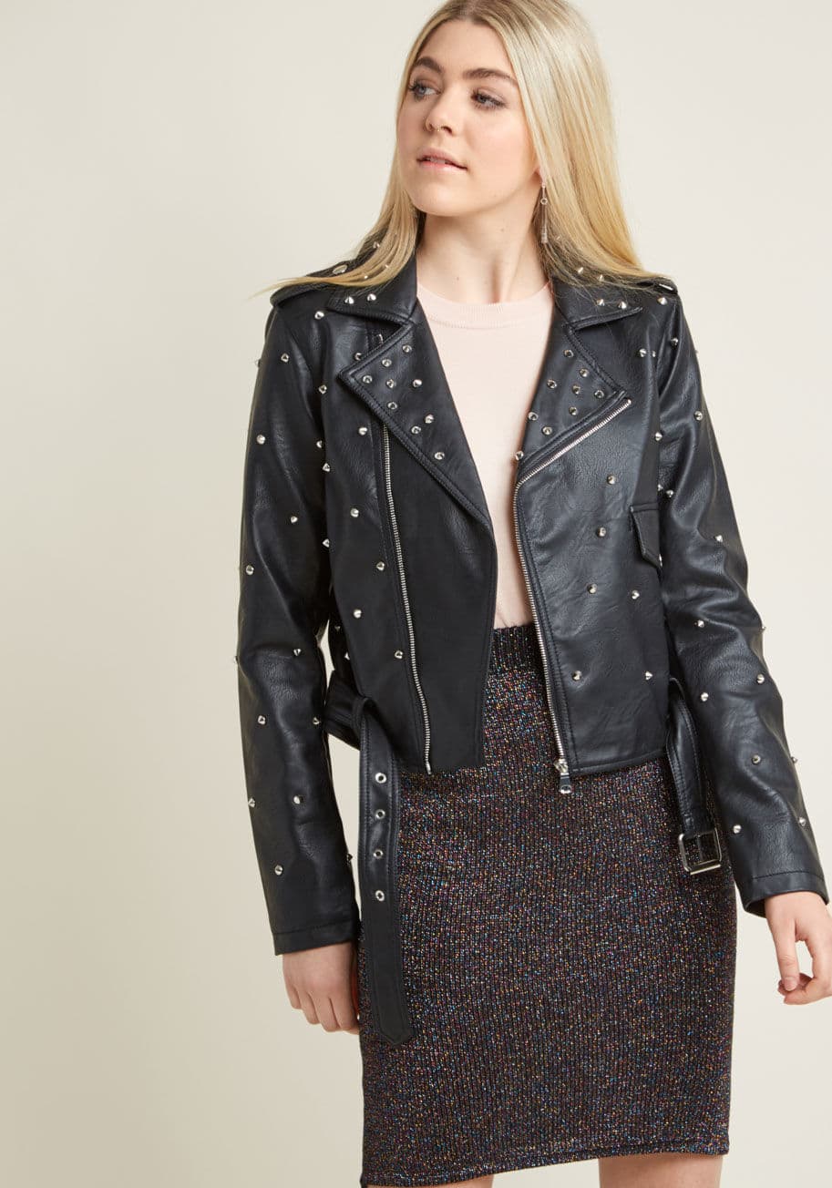 PUJK196 - As soon as inspiration to go all-in edgy strikes, this black, faux-leather moto jacket will be waiting! Flush with silver studs, fastened with an off-centered zipper, and fixed up with epaulets, a flap pocket, and a pink-and-red tiger back patch, this bel