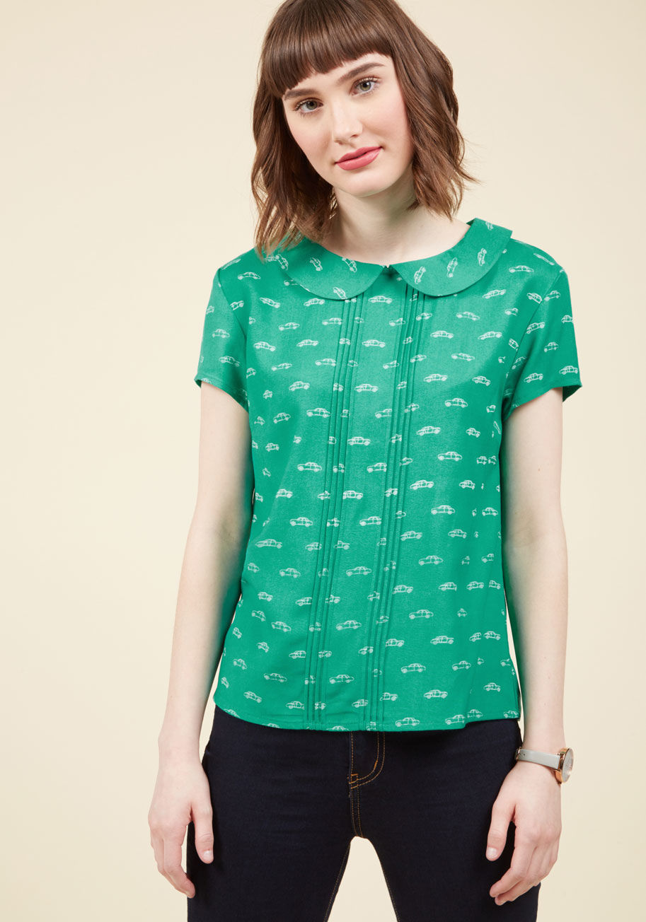 PV802 - You want the deets on this green top? Well girl, we're here to deliver! Flaunting a Peter Pan collar, a pleated placket, and playful, ModCloth-exclusive print of white automobiles with a retro inflection, this short-sleeved blouse is one you'll want to sp