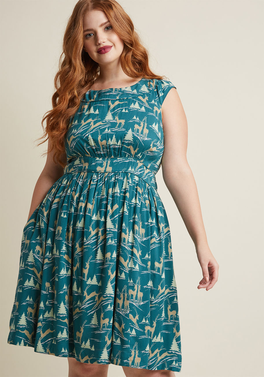 RCD-0235VR - This pocketed dress by hard-to-find British brand Emily and Fin will lift your spirits when you need it! Finessed with a boat neckline, ruched bodice, pockets, and a ModCloth-exclusive print of pale green pine trees and prancing stags flourishing atop ric