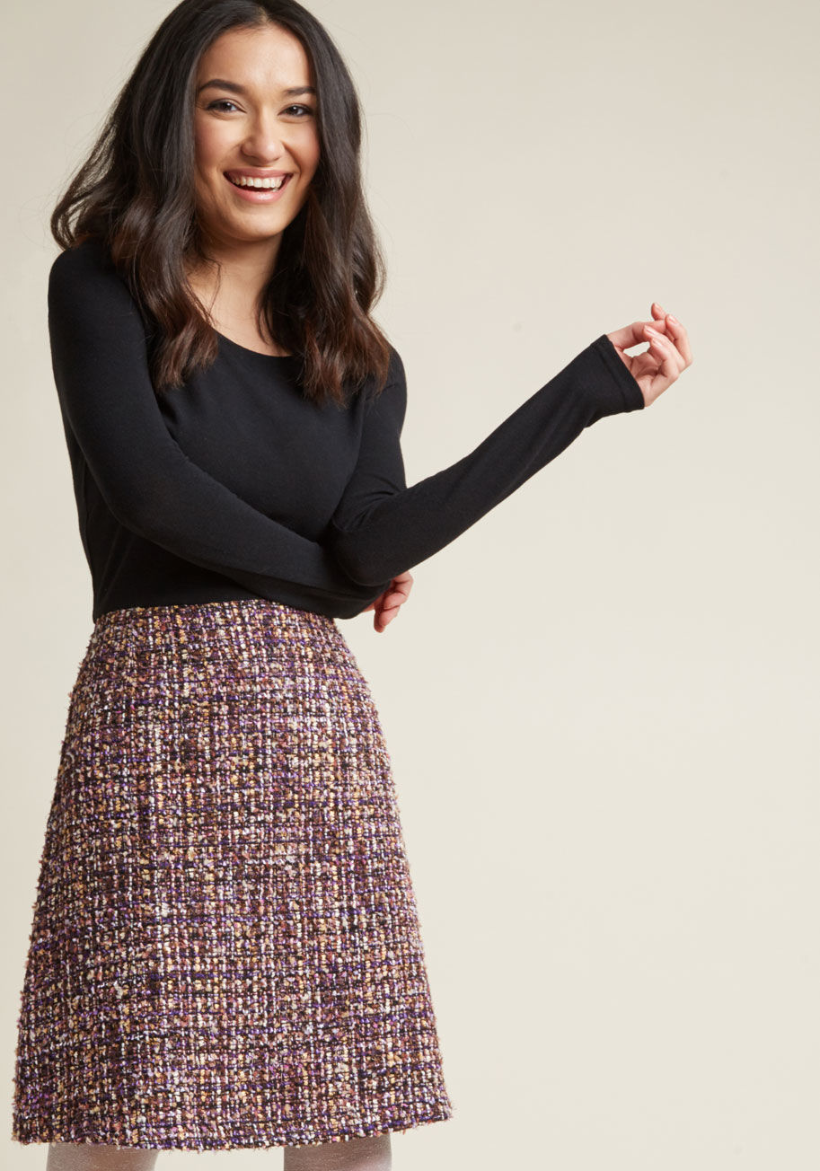 SM10189 - Put your most fabulous foot forward by flaunting this fancy twofer dress! Its black, knit bodice boasts lovely long sleeves, while its tweed skirt glows with purple, gold, and silver texturing. Inviting abundance is one great feature you and this frock ha