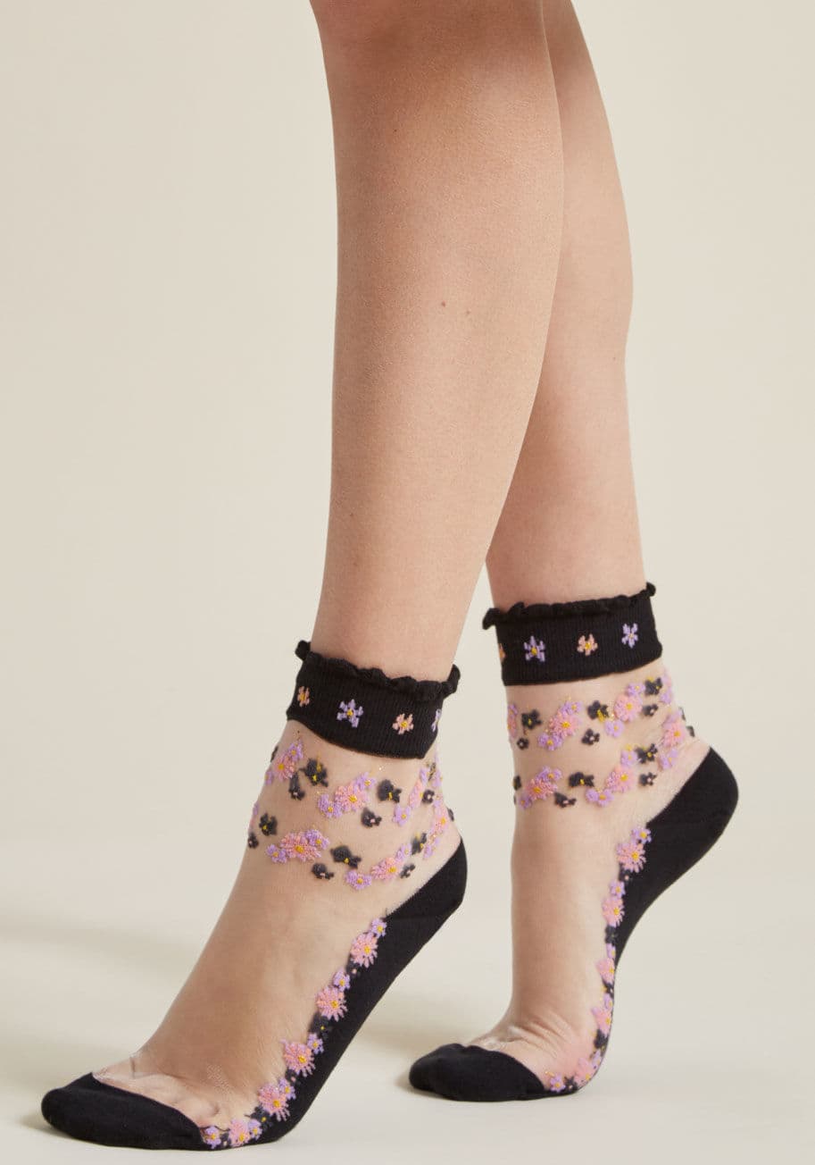 Style 1 - Treat your tootsies to a garden of blooming style, courtesy of these sheer socks! Touched with pink, purple, and black flowers sparkling with sprinkles of metallic gold, this black-bottom pair cultivates a rejuvenated appreciation for fun footwear.