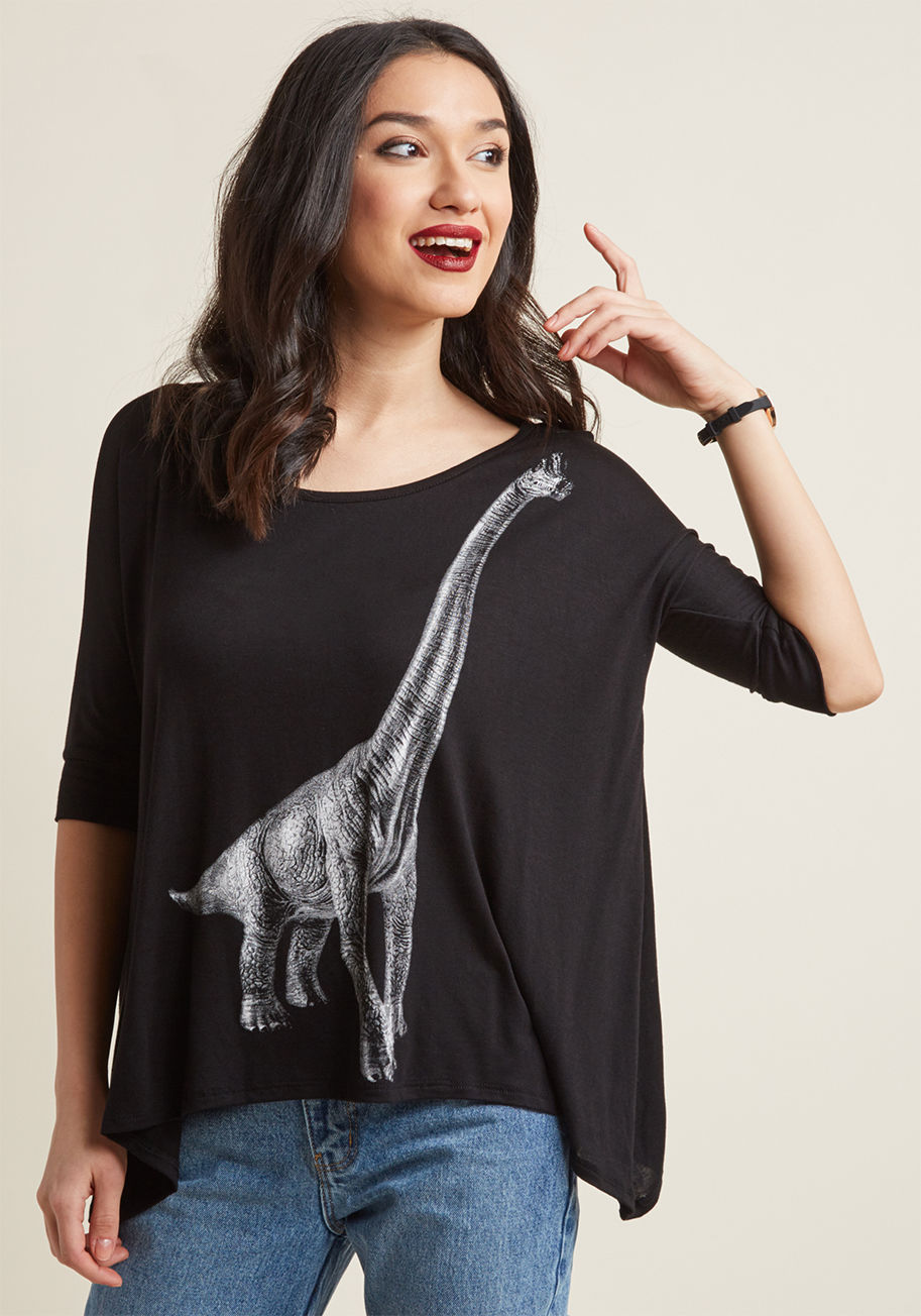 T13306-5 - If all anyone wants to talk about is this black dinosaur top you're wearing, of course you don't mind! Quite the conversation piece, this jersey knit tee employs 3/4-length dolman sleeves and a brachiosaurus buddy graphic for a fun look that'll go down in