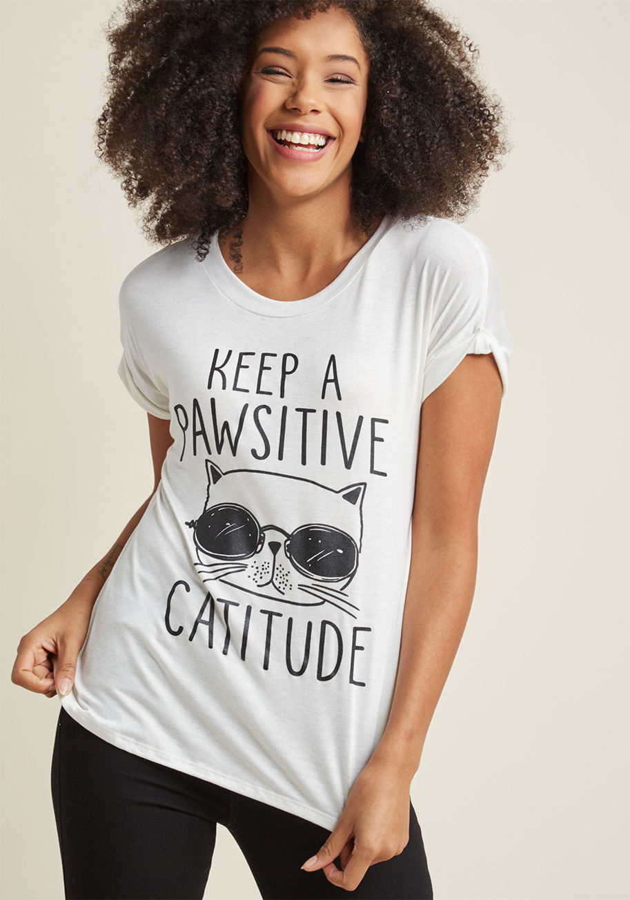 T13307-9 - If you need a little reminder to uplift your outlook, turn to this white graphic tee! Chock-full of cat pun goodness, this ModCloth-exclusive top commands a smile from everyone around - including the wearer!