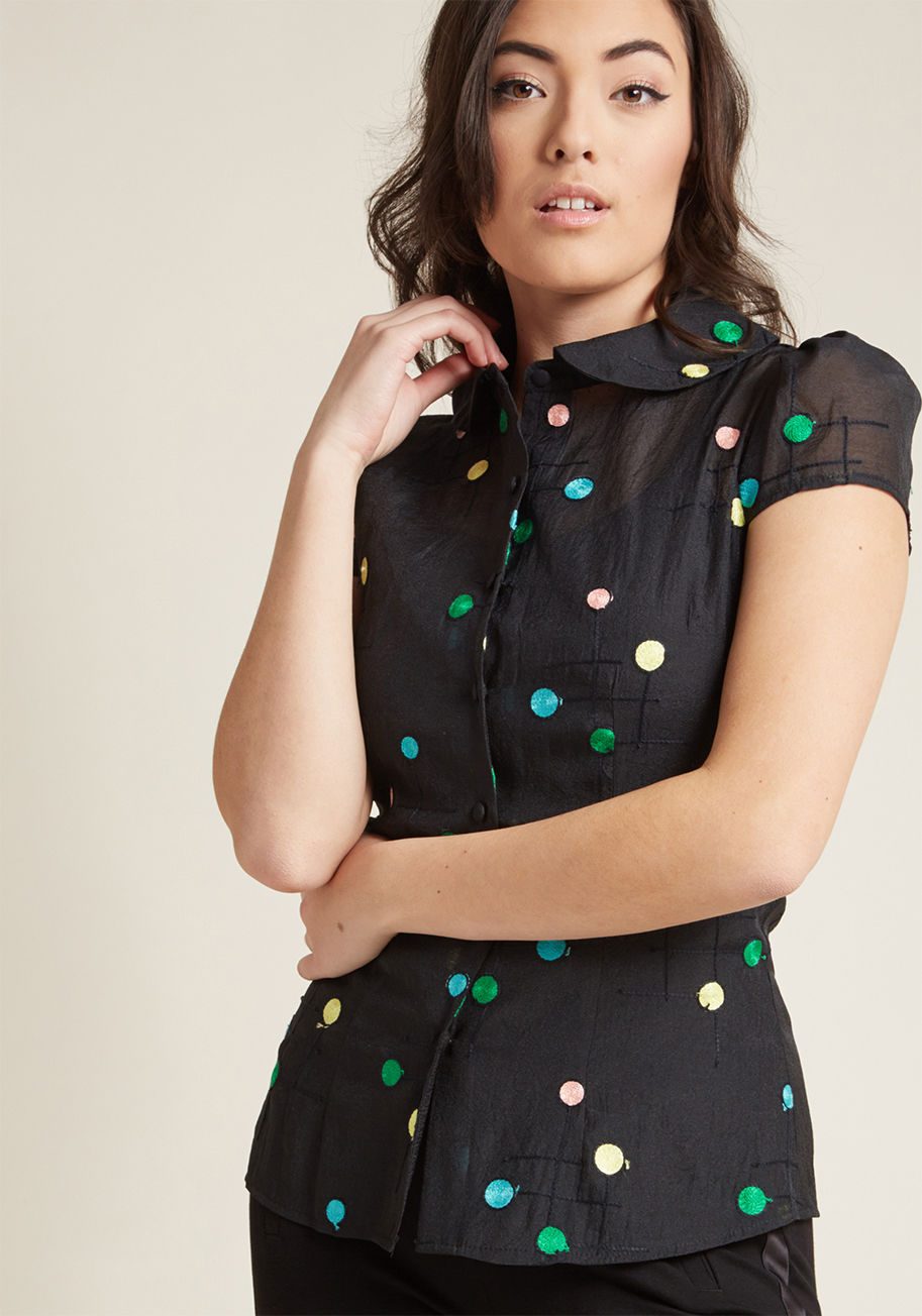 TPA1830 - Oh, the incredible difference a few colorful dots can make! On its own, this black shirt is simply darling with its rounded collar, short sleeves, and sheer crepe-y material. However, the addition of yellow, green, pink, and blue embroidered spots transfo