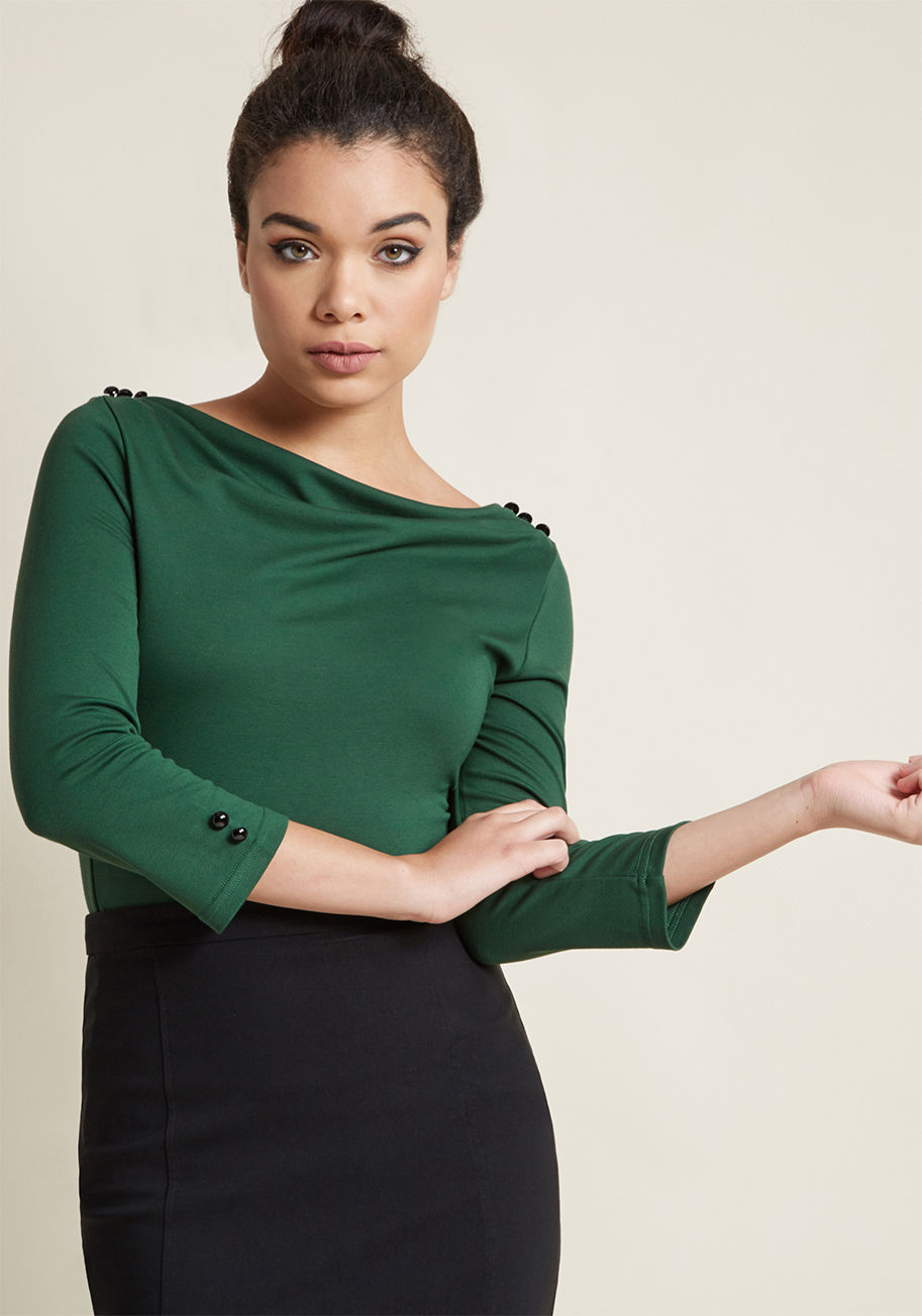 TPA1881 - If this green top doesn't remind you of style from bygone times, we don't know what will! Glossy black buttons frame the bateau neckline pleats, fasten the back keyhole, and top the cropped sleeves of this sassy separate, making it a retro wardrobe staple