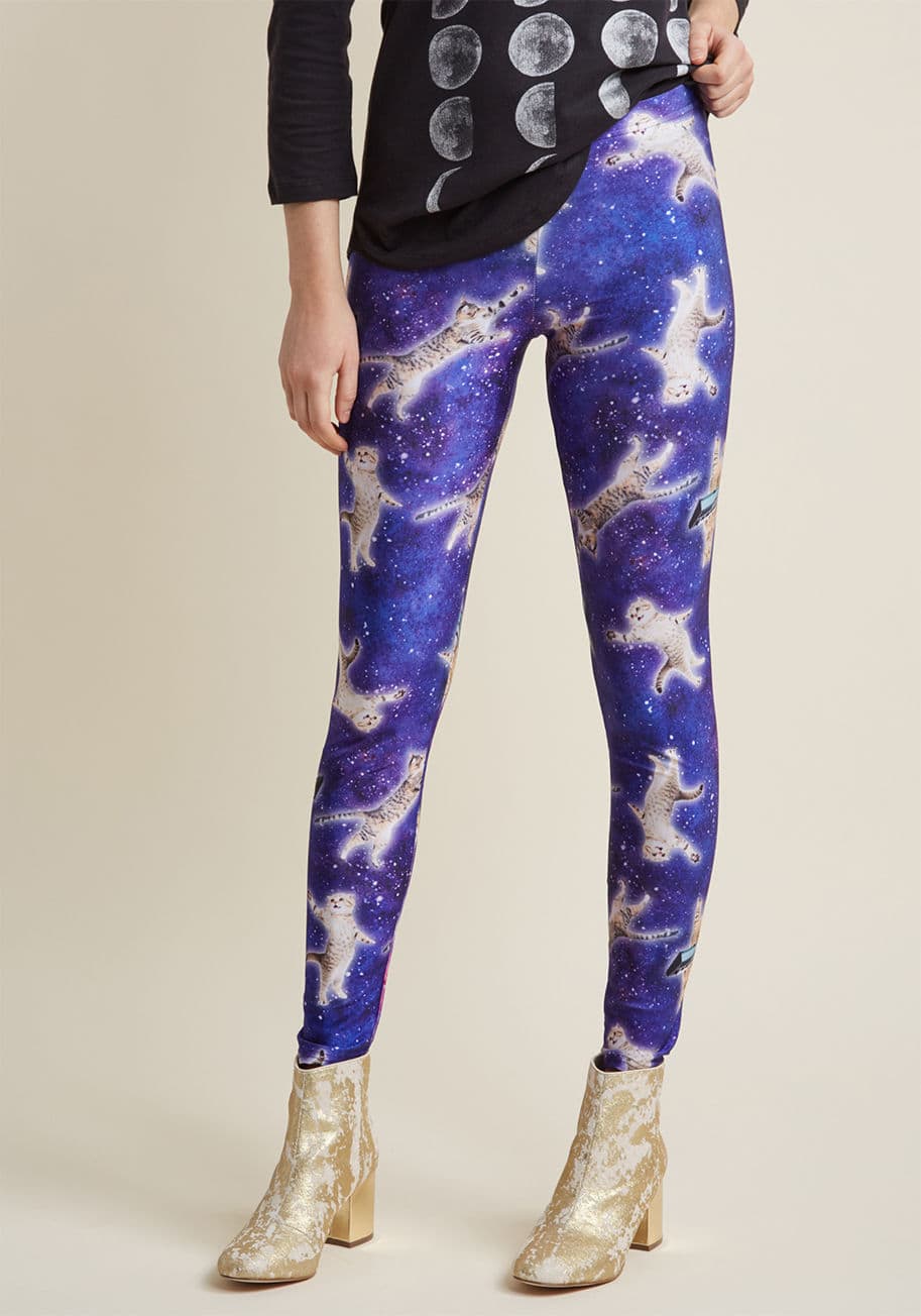 V2309 - Cats are known rule-breakers, and these cosmic leggings show kitties taking that idea to an astronomical extreme! Floating through a starry, indigo atmosphere are felines flying, floating, and playing the keyboard, creating a stretchy ModCloth-exclusive p