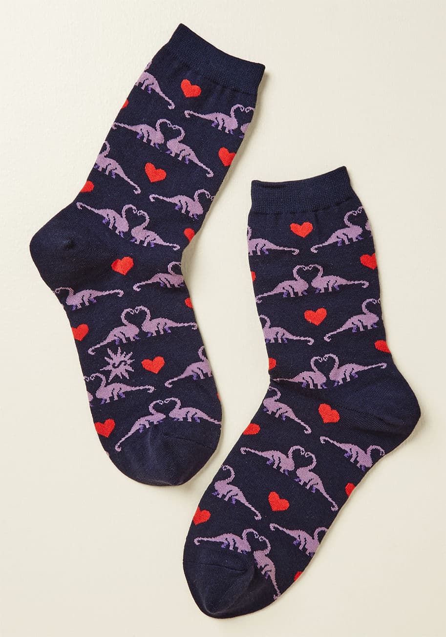 W0108 - Adoration has existed for as long as time, and the purple Brachiosaurus nuzzling on these navy blue socks are proof that love is still alive! Accented with red hearts and made from a comfy knit, these cute crews will have you wanting to canoodle, too.