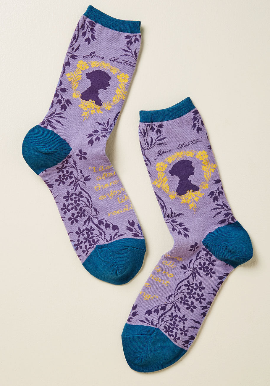 WNC717 - An aspiring novelist yourself, you look up to the great Jane Austen while you look down at these literary crew socks! Their lavender knit boasts floral vines, a yellow-framed silhouette of the writer herself, ocean blue trim, and a reading-centric quote t