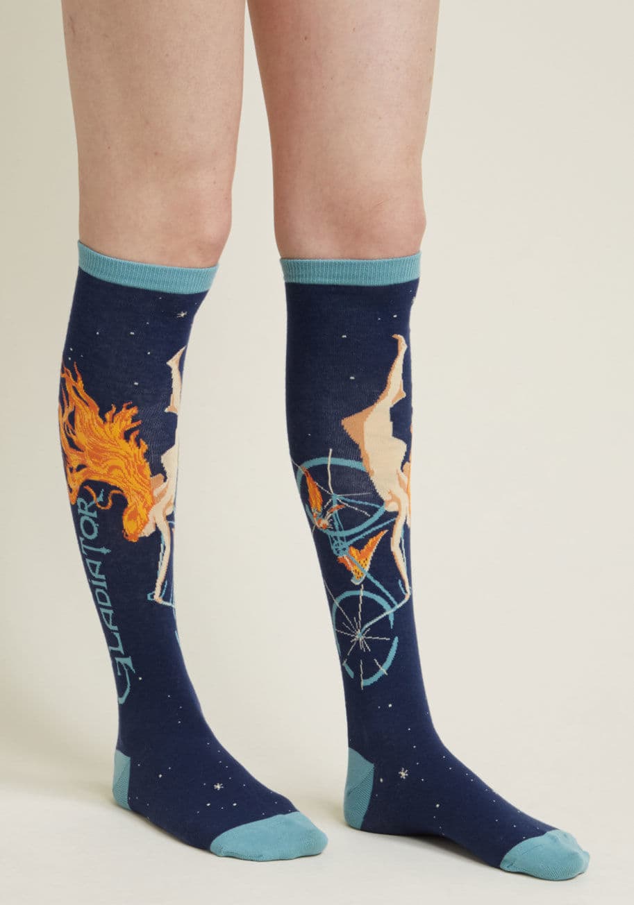 Wnh922 - While your mouth sips your favorite wine, snuggle your toes into these oh-so-on-theme knee socks! Flaunting the Cycles Gladiator girl, who has recently made her comeback on labels, this navy, sky blue, orange, and beige footwear allows for a 'full-bodied'