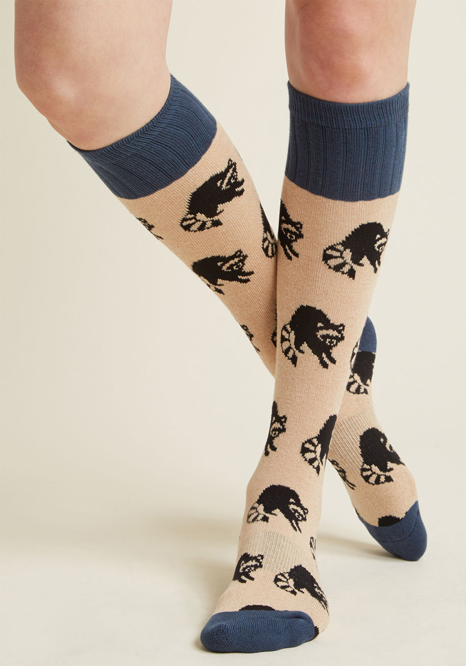 WOB985 - Do you hear that? Why, it's the voice of reason saying these tan socks offer the perfect peppering of quirk for your wardrobe! Printed with black raccoons aplenty and capped at the calves, heels, and toes with a solid blue hue, this pair is one you've jus