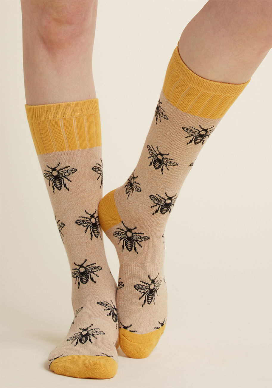 WOB994 - Do you hear that? Why, it's the voice of reason saying these tan socks offer the perfect peppering of quirk for your wardrobe! Printed with black bees aplenty and capped at the calves, heels, and toes with a solid honey hue, this pair is one you've just g