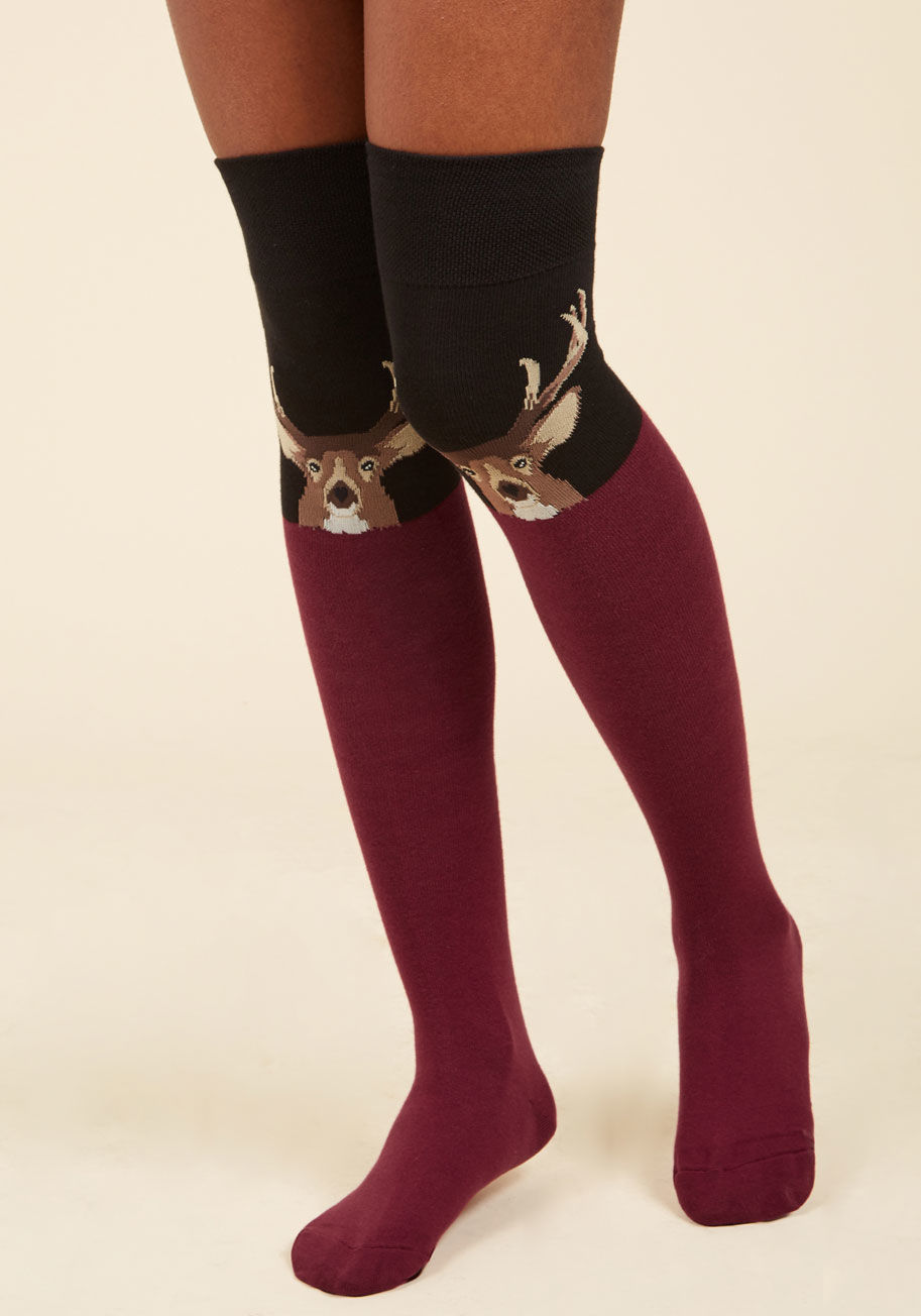 WOK738 - Want to try out some over-the-knee socks? Get your collection started with this black pair! Touting a stoic brown stag peeking over each burgundy colorblock, these thigh-highs will quickly become the 'deerest' pair